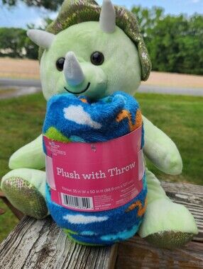 Plush Green Triceratops Holding Blue Patterned Throw